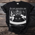 Black t-shirt with "do not perceive me" text and a distressed graphic of a startled black cat in a sink.