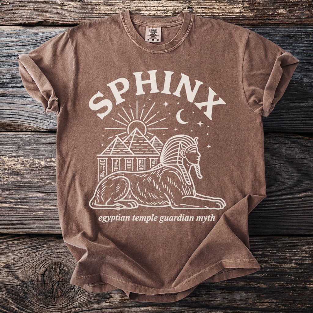 Brown t-shirt with Sphinx and pyramids graphic, reading "Sphinx" and "egyptian temple guardian myth."