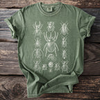 Green t-shirt with a white illustration of various beetles and insects.
