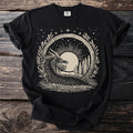 Black t-shirt with a cream-colored linocut style graphic of a sea serpent and moon.