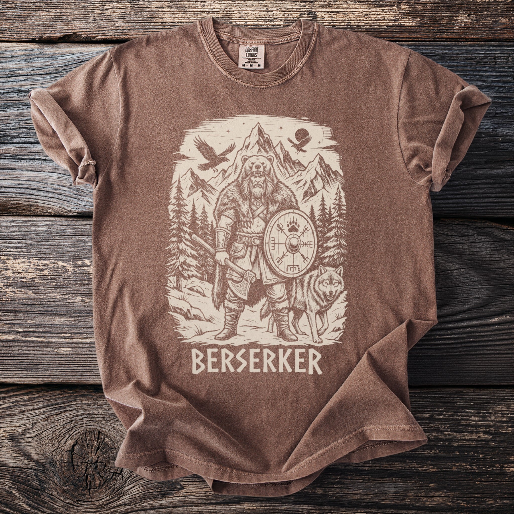 Brown t-shirt with a graphic of a bear-man, wolf, and Viking shield.