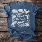 Blue t-shirt with a white line drawing of reptiles and amphibians with "respect the locals" text.