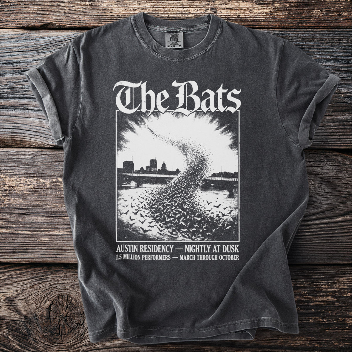 T-shirt with "The Bats" text and a graphic of bats flying over a city skyline.