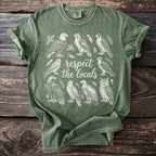 Green t-shirt with white line art of various birds and text "respect the locals".