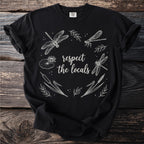 Black t-shirt with "respect the locals" and white dragonfly, lily pad, and cattail illustration.