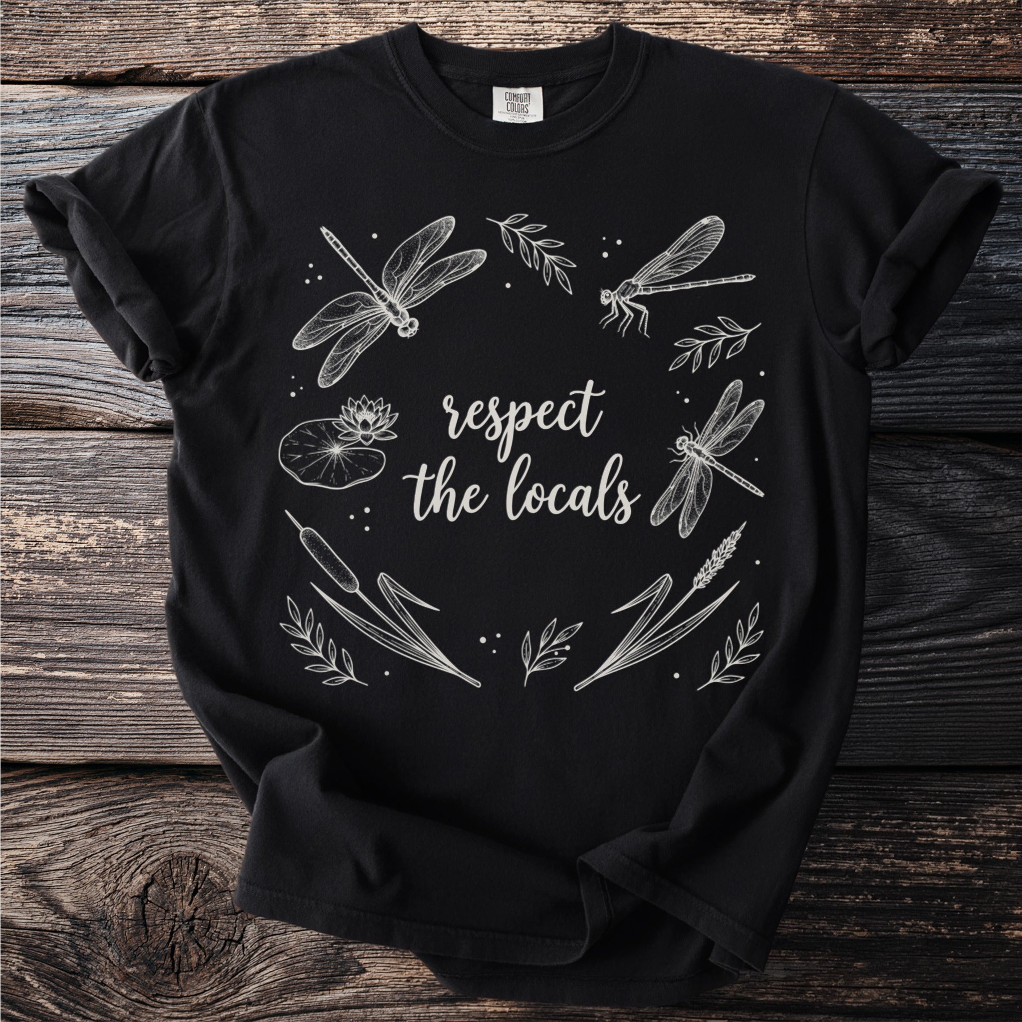 Black t-shirt with "respect the locals" and white dragonfly, lily pad, and cattail illustration.