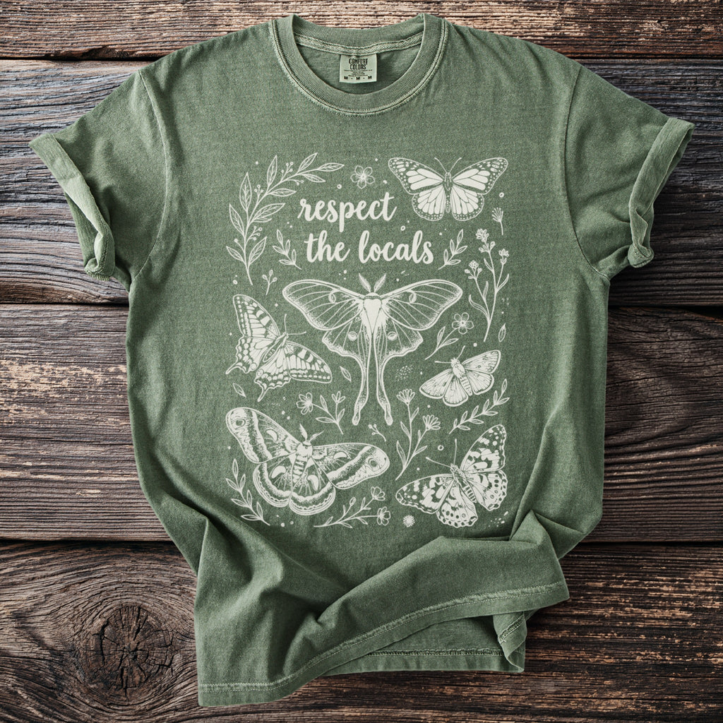 Green t-shirt with white line art of various butterflies and "respect the locals" text.