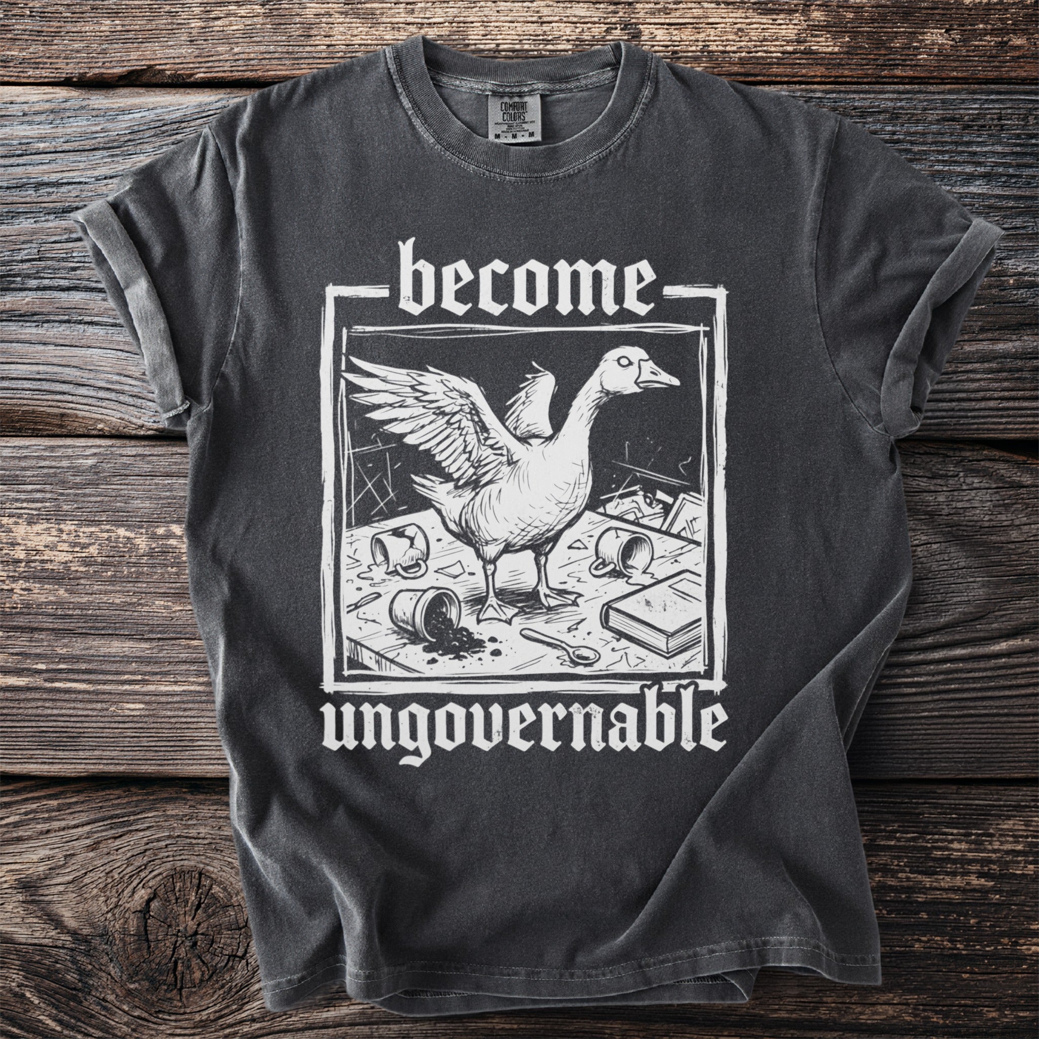 Dark grey t-shirt with white text and illustration of a goose.