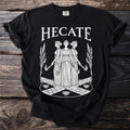 Black t-shirt with white HECATE text and three-headed goddess graphic.