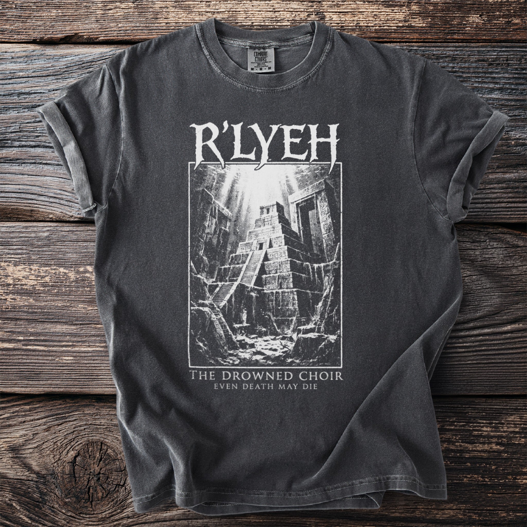 Dark t-shirt with white graphic of R'LYEH and "The Drowned Choir Even Death May Die" text.