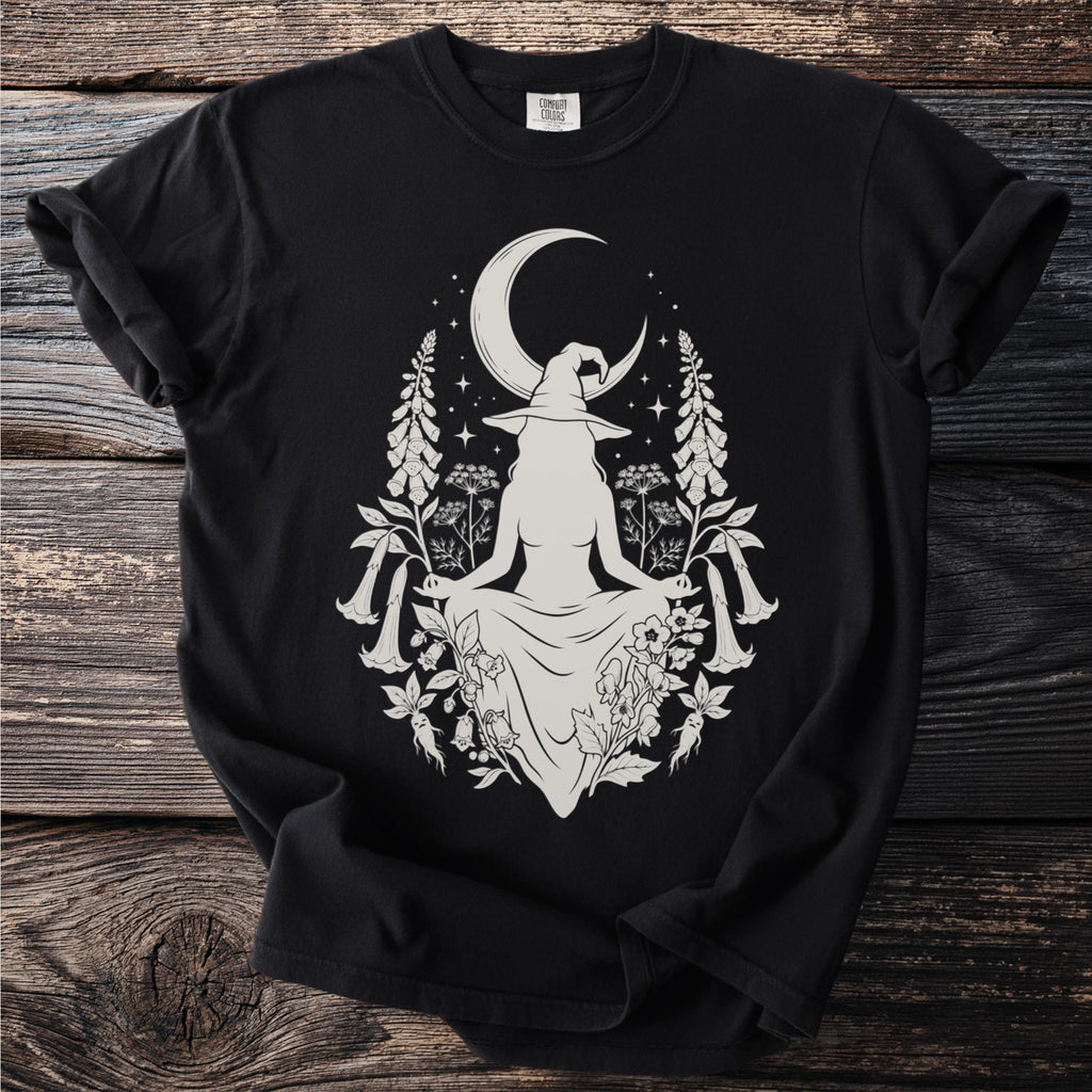 Witch with crescent moon and floral design on black t-shirt.