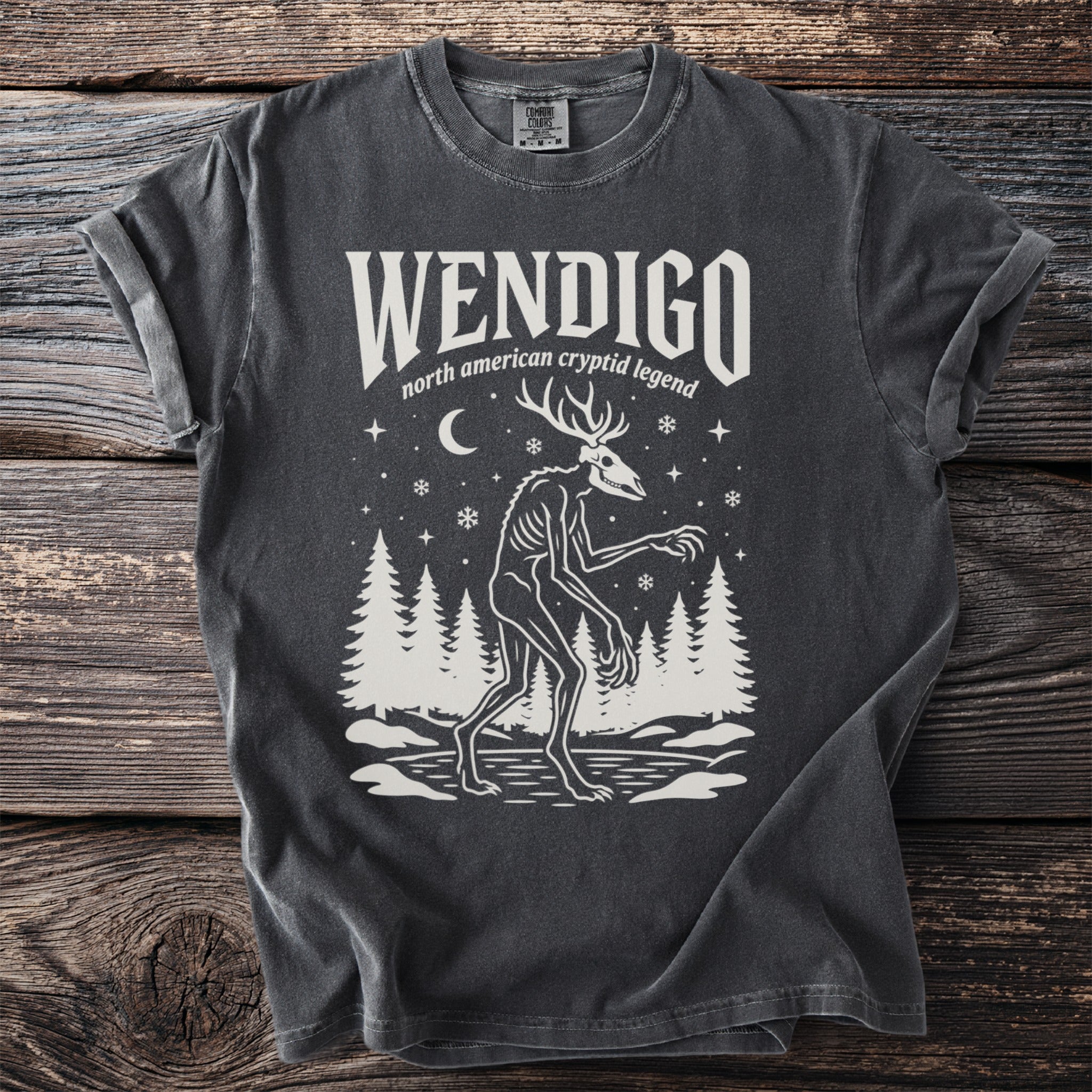 Dark grey t-shirt with white graphic of a Wendigo and text "Wendigo north american cryptid legend".