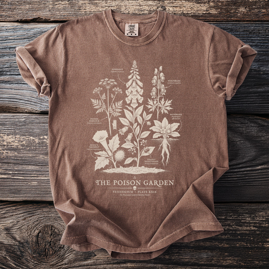 Brown t-shirt featuring vintage botanical illustrations of poisonous plants labeled "The Poison Garden."