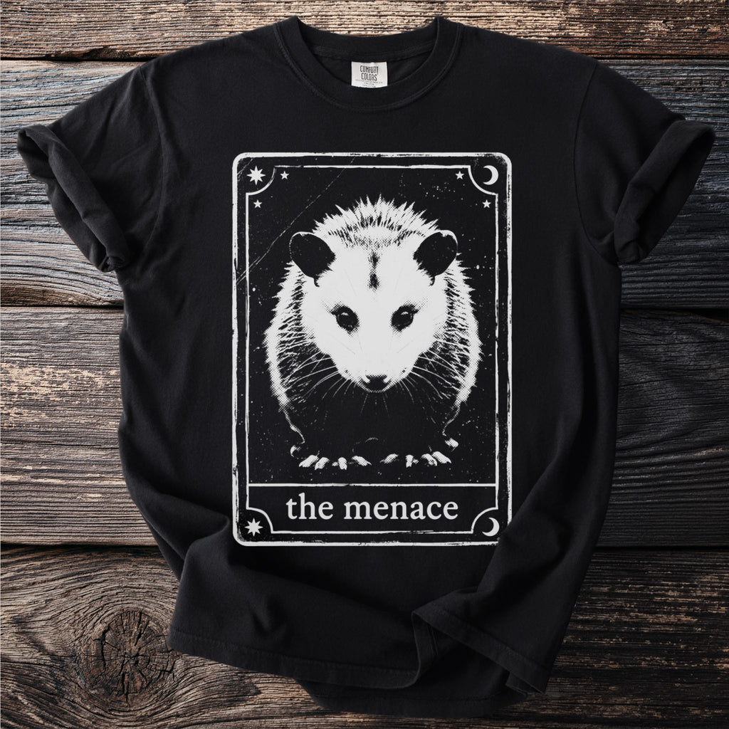 Black t-shirt with a distressed tarot card design featuring an opossum and text "the menace".