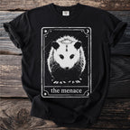 Black t-shirt with a distressed tarot card design featuring an opossum and text "the menace".