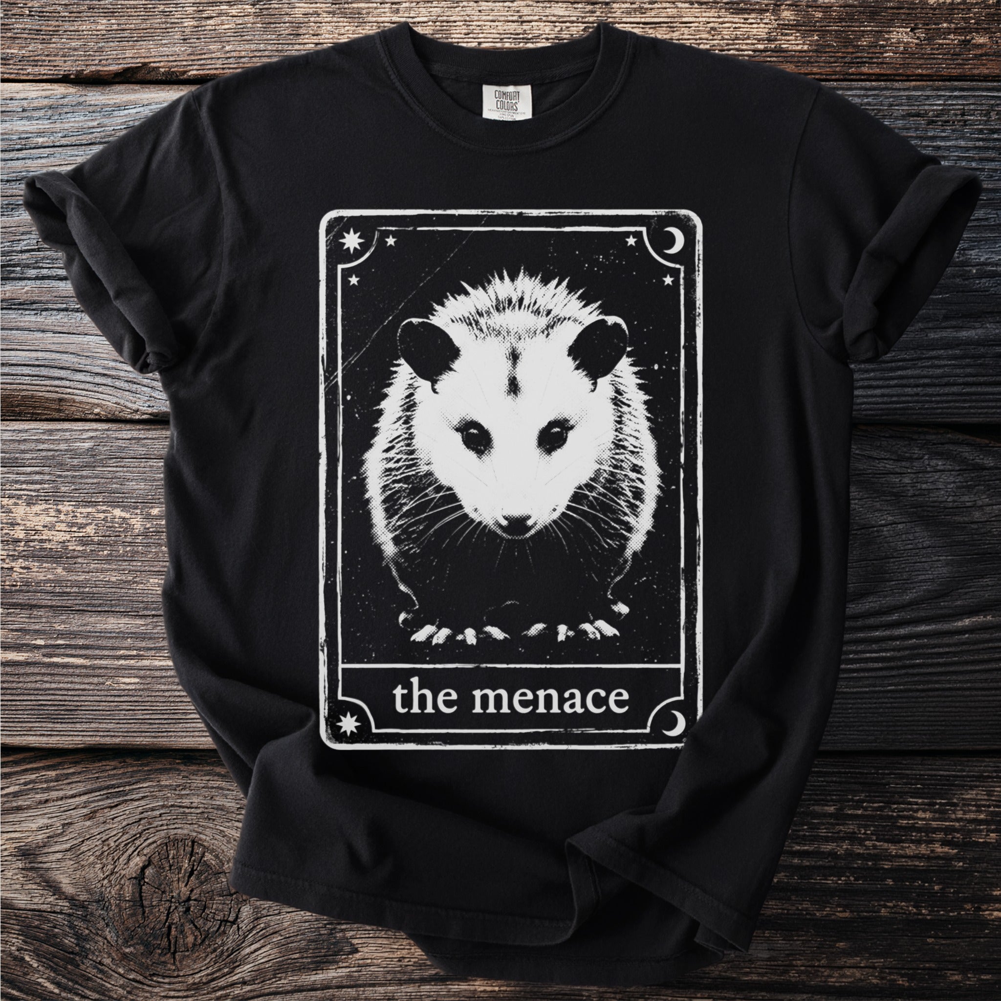 Black t-shirt with a distressed tarot card design featuring an opossum and text "the menace".