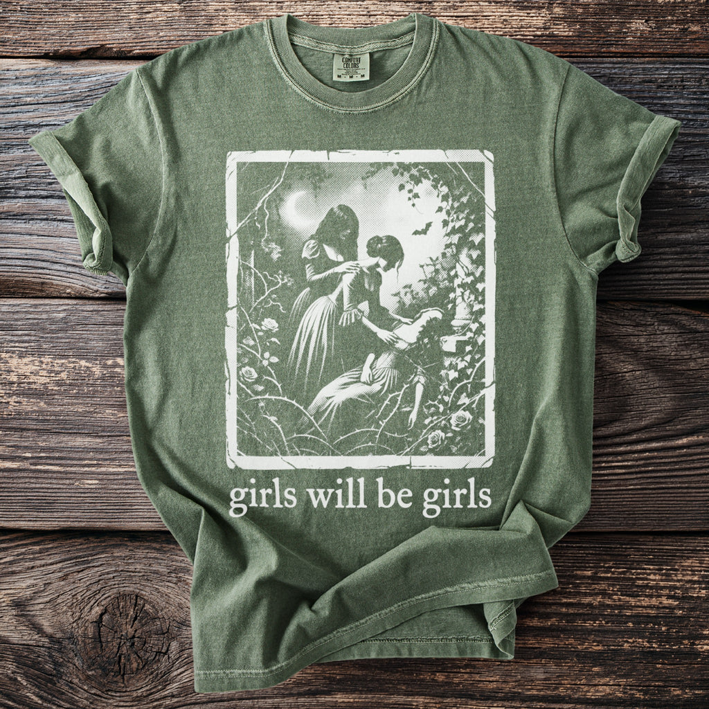 Olive green t-shirt with "girls will be girls" text and vintage illustration.