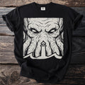 Black t-shirt with a distressed graphic of a monstrous face and a lighthouse in the waves.