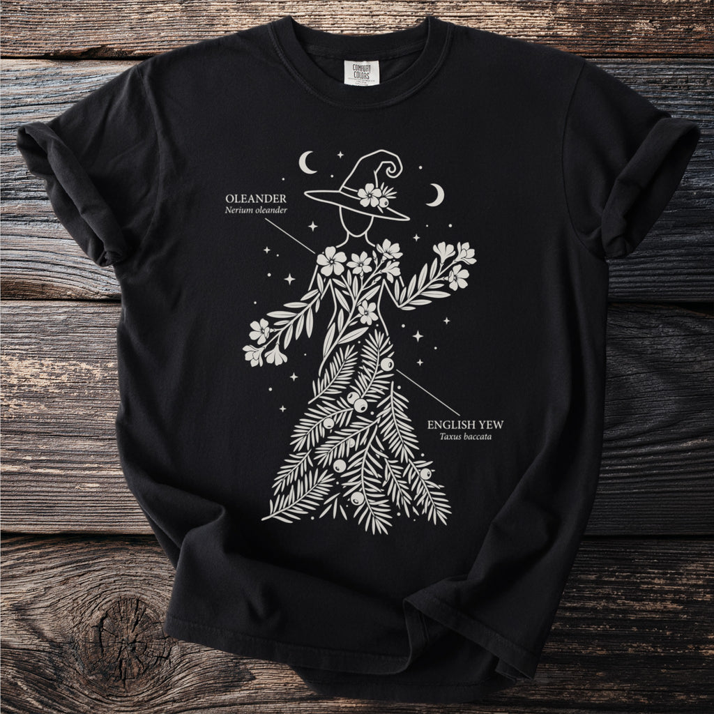 Black t-shirt with line art of a witch adorned with oleander and English yew branches and berries.