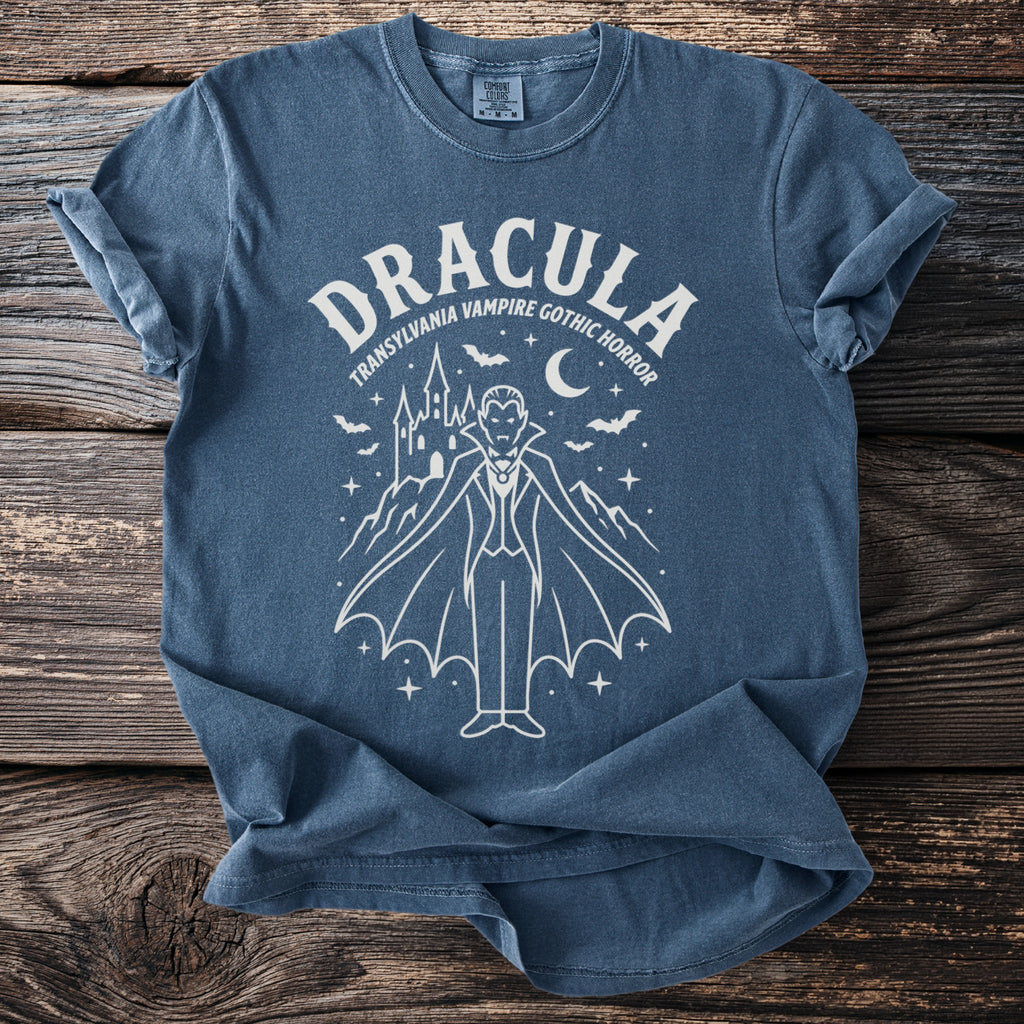 Blue t-shirt with white graphic of Dracula, castle, bats, and moon.