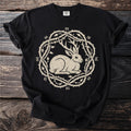 Black t-shirt with a cream print of a rabbit with antlers in a thorny circle with runes.