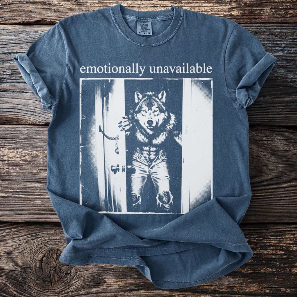 T-shirt with "emotionally unavailable" text and a wolf-man graphic in ripped jeans.