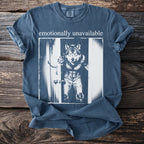 T-shirt with "emotionally unavailable" text and a wolf-man graphic in ripped jeans.