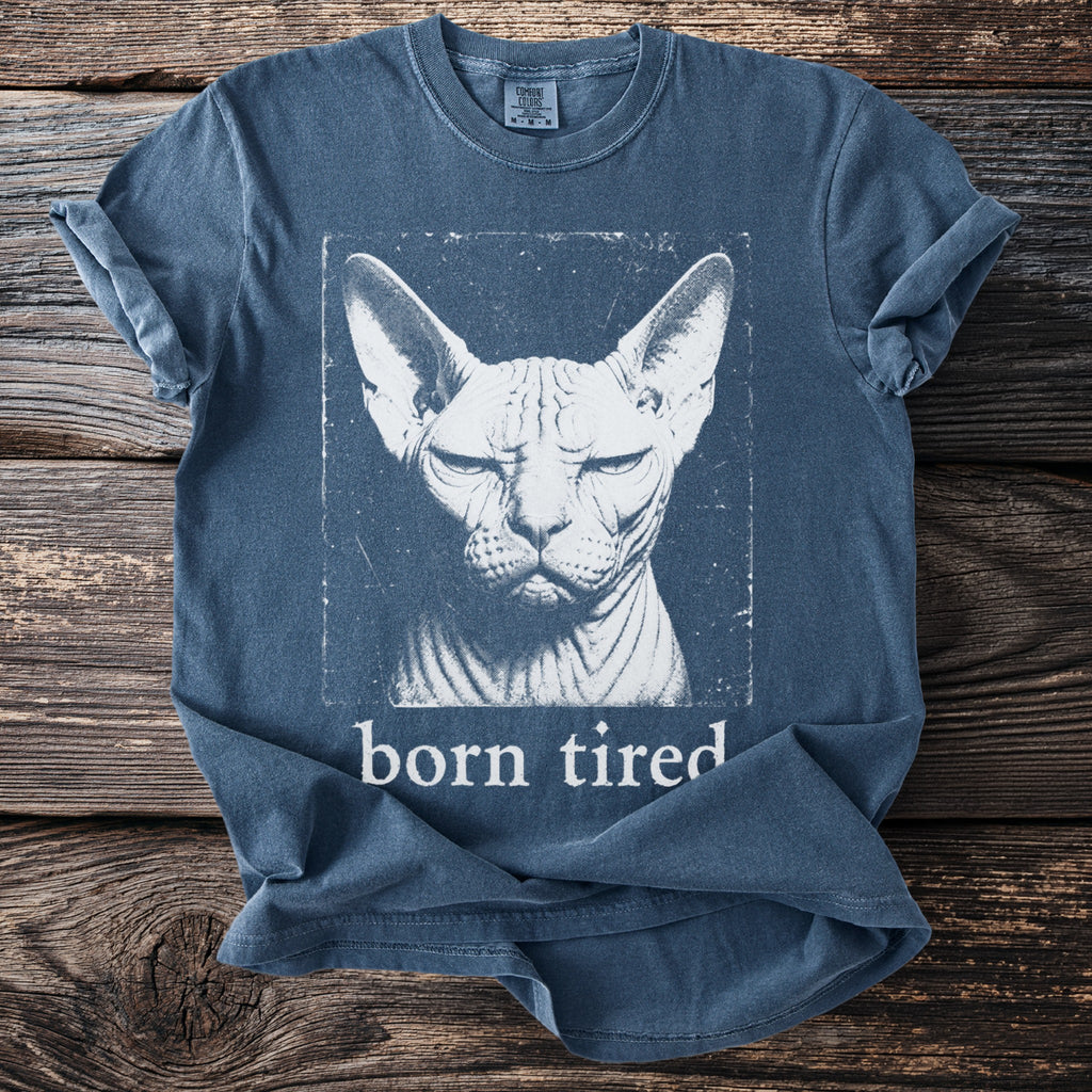Blue t-shirt with a distressed graphic of a Sphynx cat and the text "born tired".