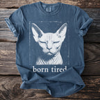 Blue t-shirt with a distressed graphic of a Sphynx cat and the text "born tired".