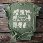 Green t-shirt with white line art of big cats and text reading "respect the locals".