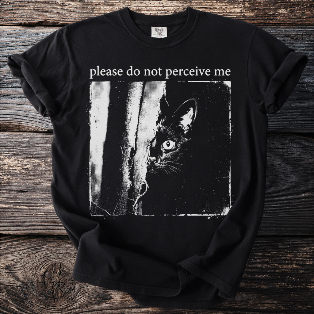 Black t-shirt with white text "please do not perceive me" and a black cat peeking.