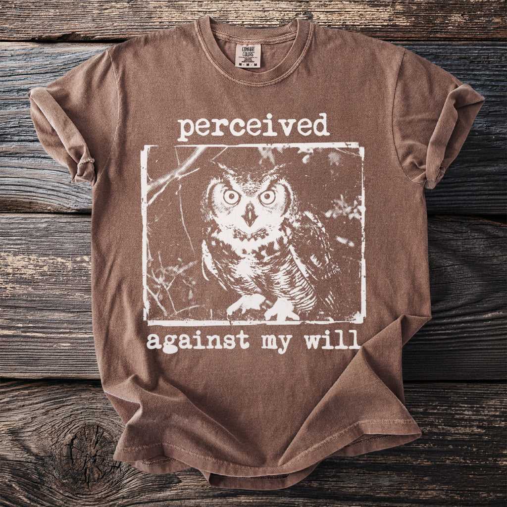Brown t-shirt with graphic of an owl and text "perceived against my will".