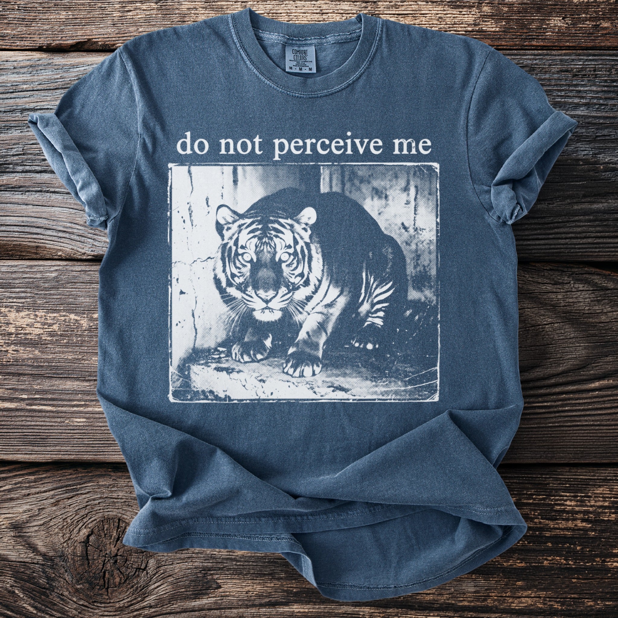 Blue t-shirt with a black and white tiger graphic and text "do not perceive me".