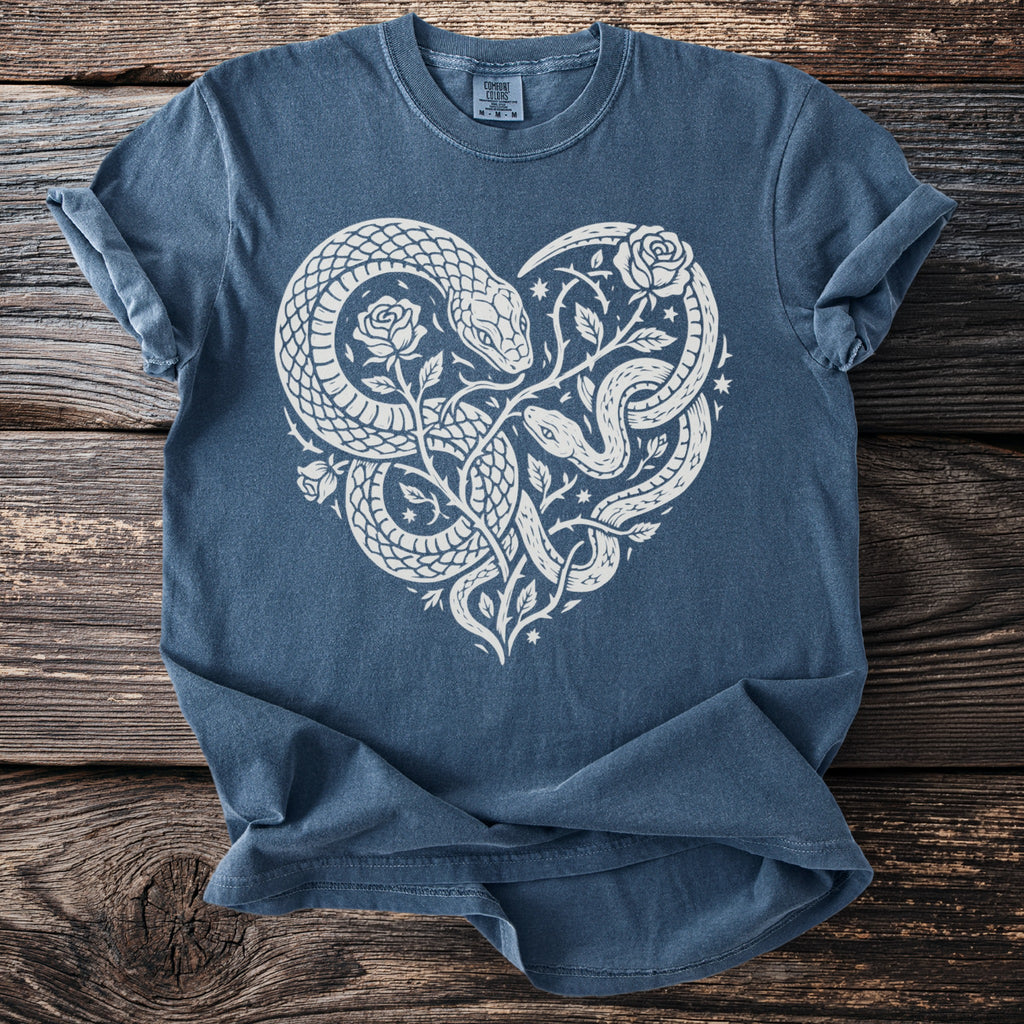 Blue t-shirt with white graphic of snakes and roses forming a heart shape.