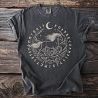Dark t-shirt with a central circular design featuring a running horse, wolf, moon, and runes.