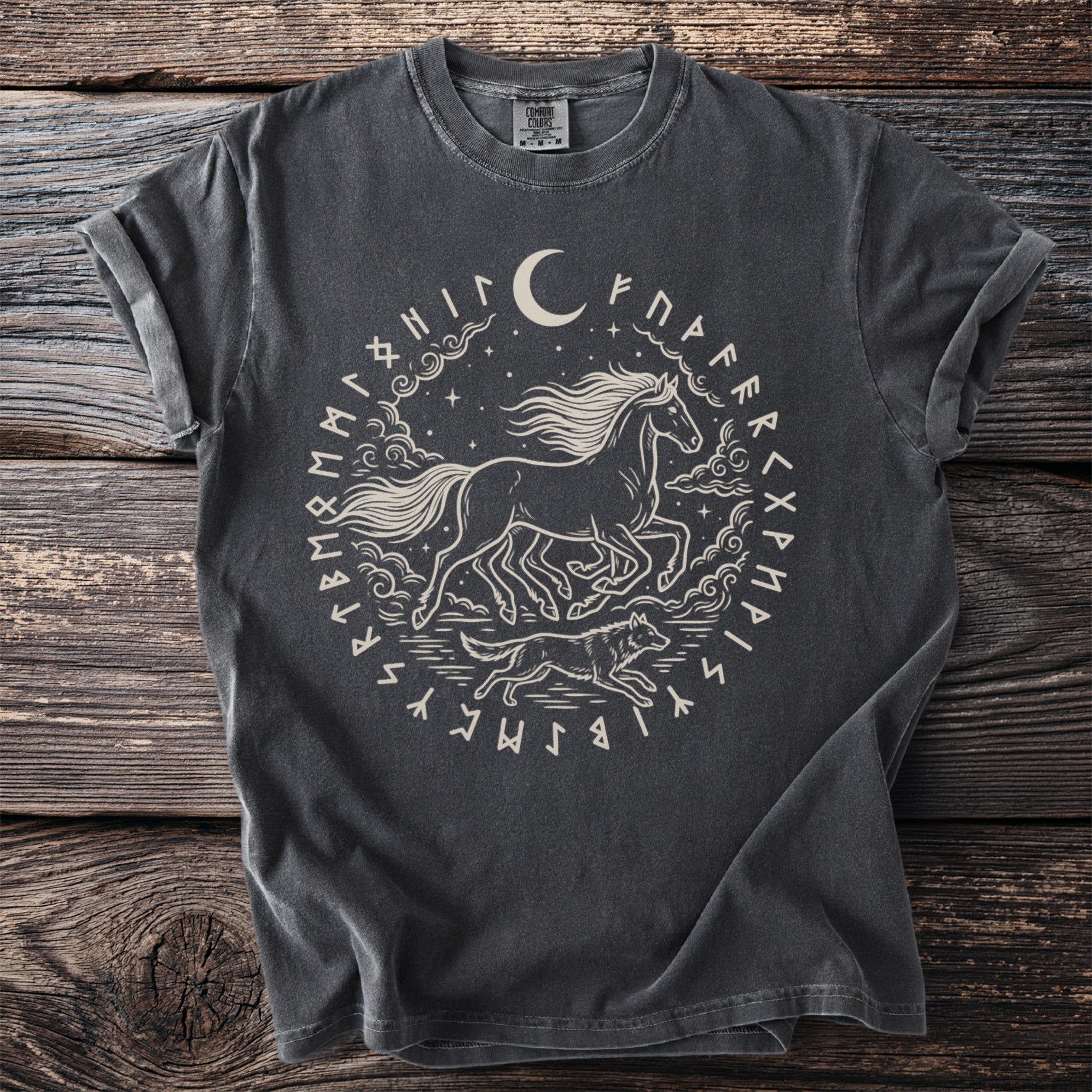 Dark t-shirt with a central circular design featuring a running horse, wolf, moon, and runes.
