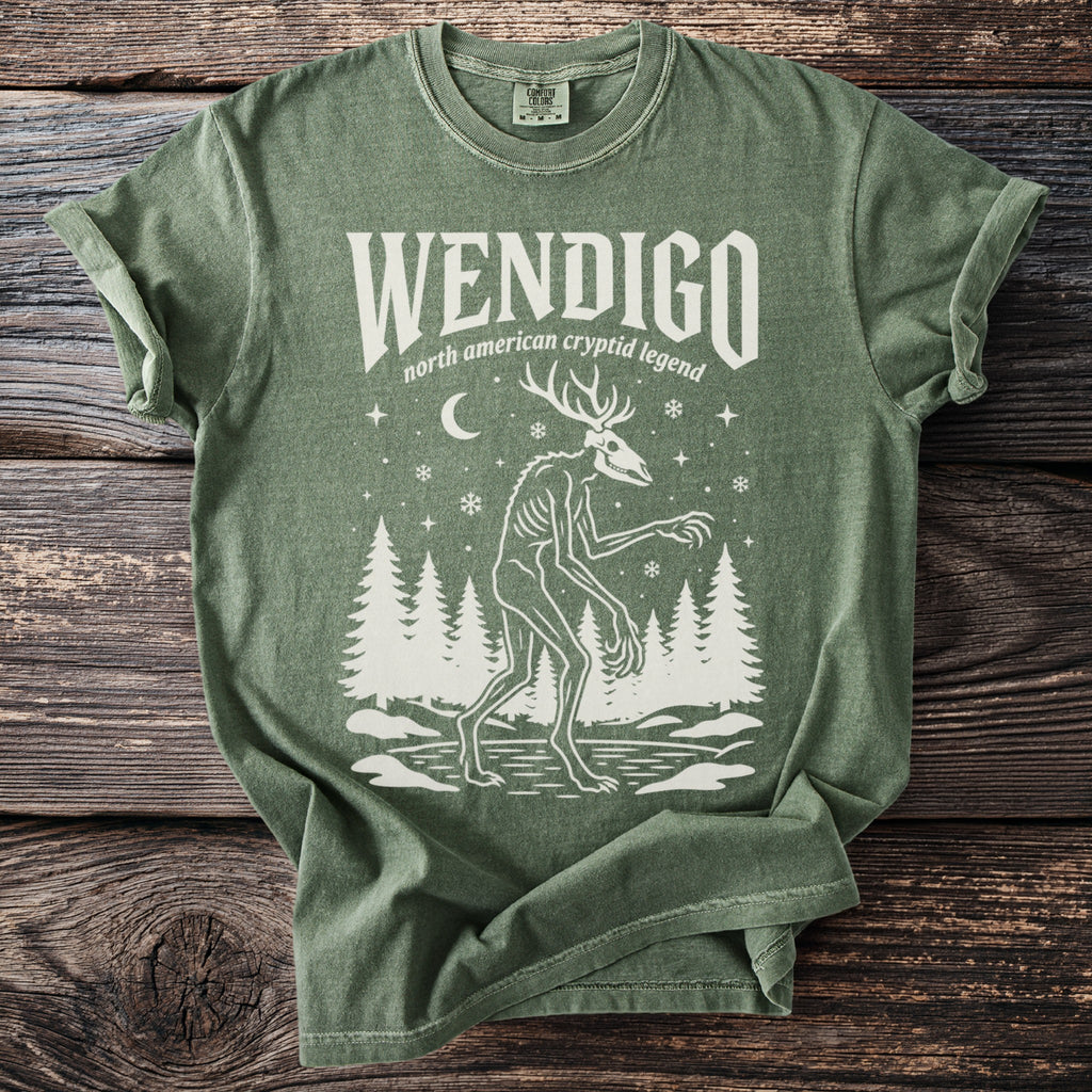 Green t-shirt with "WENDIGO north american cryptid legend" and a skeletal figure.