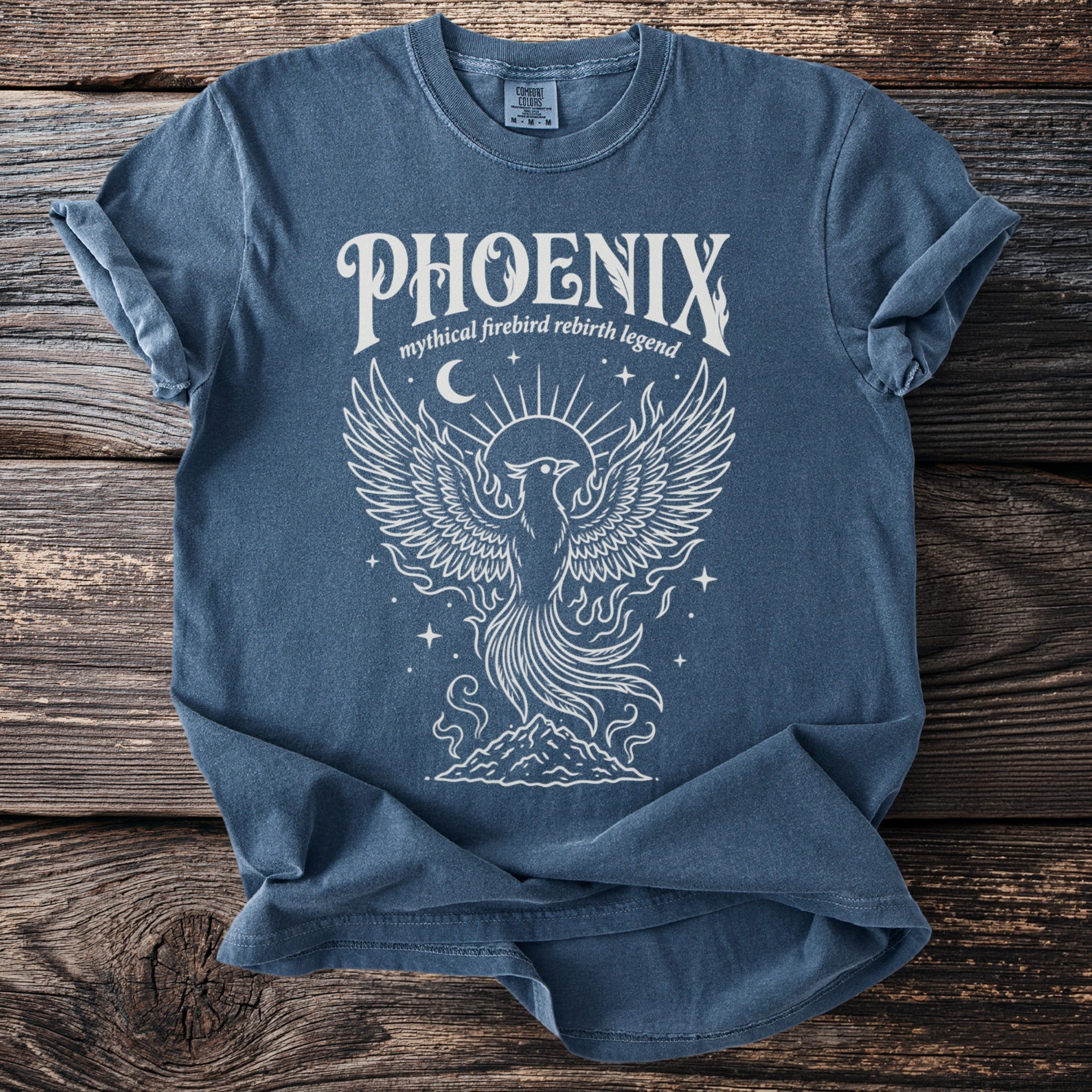 Blue t-shirt with white phoenix graphic and text "PHOENIX mythical firebird rebirth legend ".