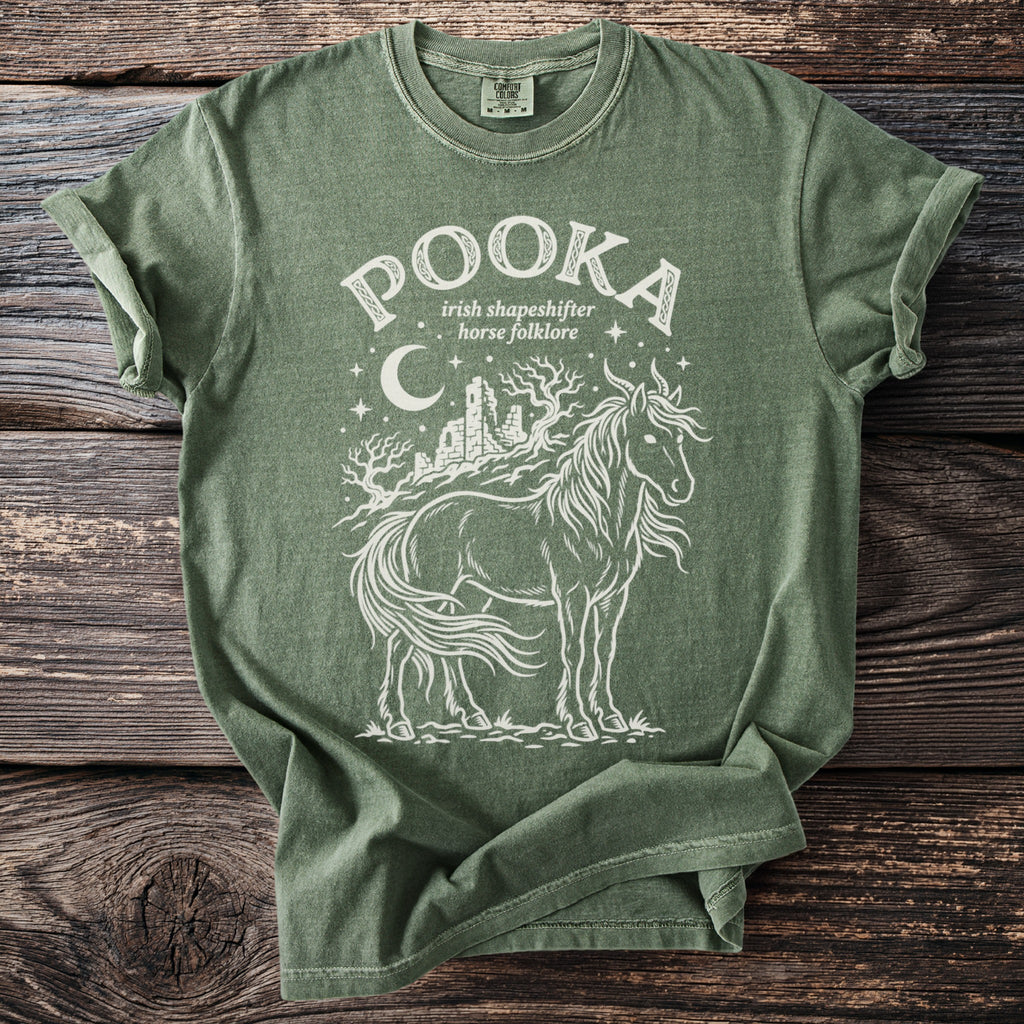 Green t-shirt with Pooka Irish shapeshifter horse folklore graphic design.