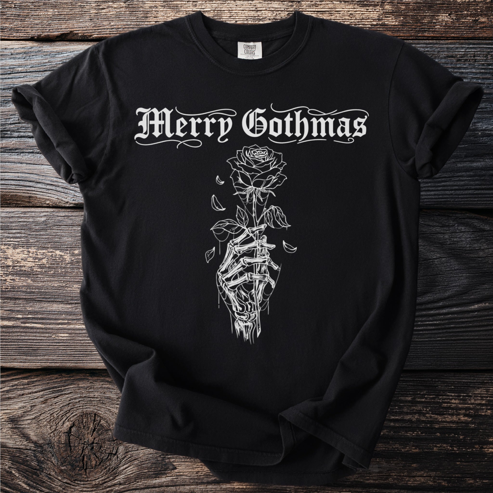 Black t-shirt with "Merry Gothmas" text and skeleton hand holding a rose graphic.