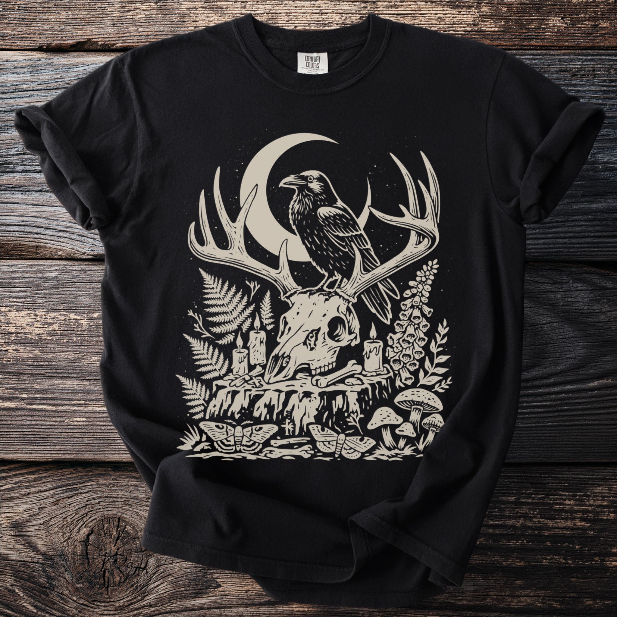 Black t-shirt with occult graphic of raven on deer skull with crescent moon.