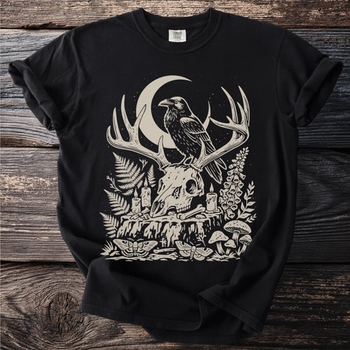 Black t-shirt with occult graphic of raven on deer skull with crescent moon.