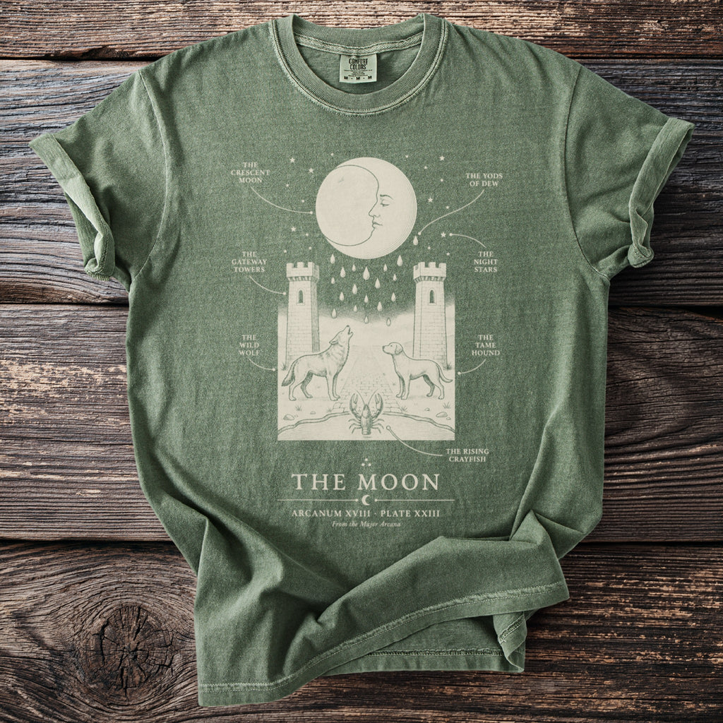 Green t-shirt with "The Moon" tarot card illustration featuring a crescent moon, towers, wolf, and dog.