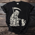 Grim Reaper in a robe petting a cat, with scythe, on a black t-shirt.