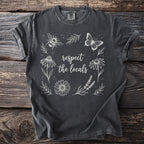 Dark grey t-shirt with white outline art of flowers, bee, butterfly, and text.
