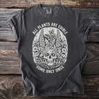 Dark grey t-shirt with skull, plants, and text: "ALL PLANTS ARE EDIBLE SOME ONLY ONCE."