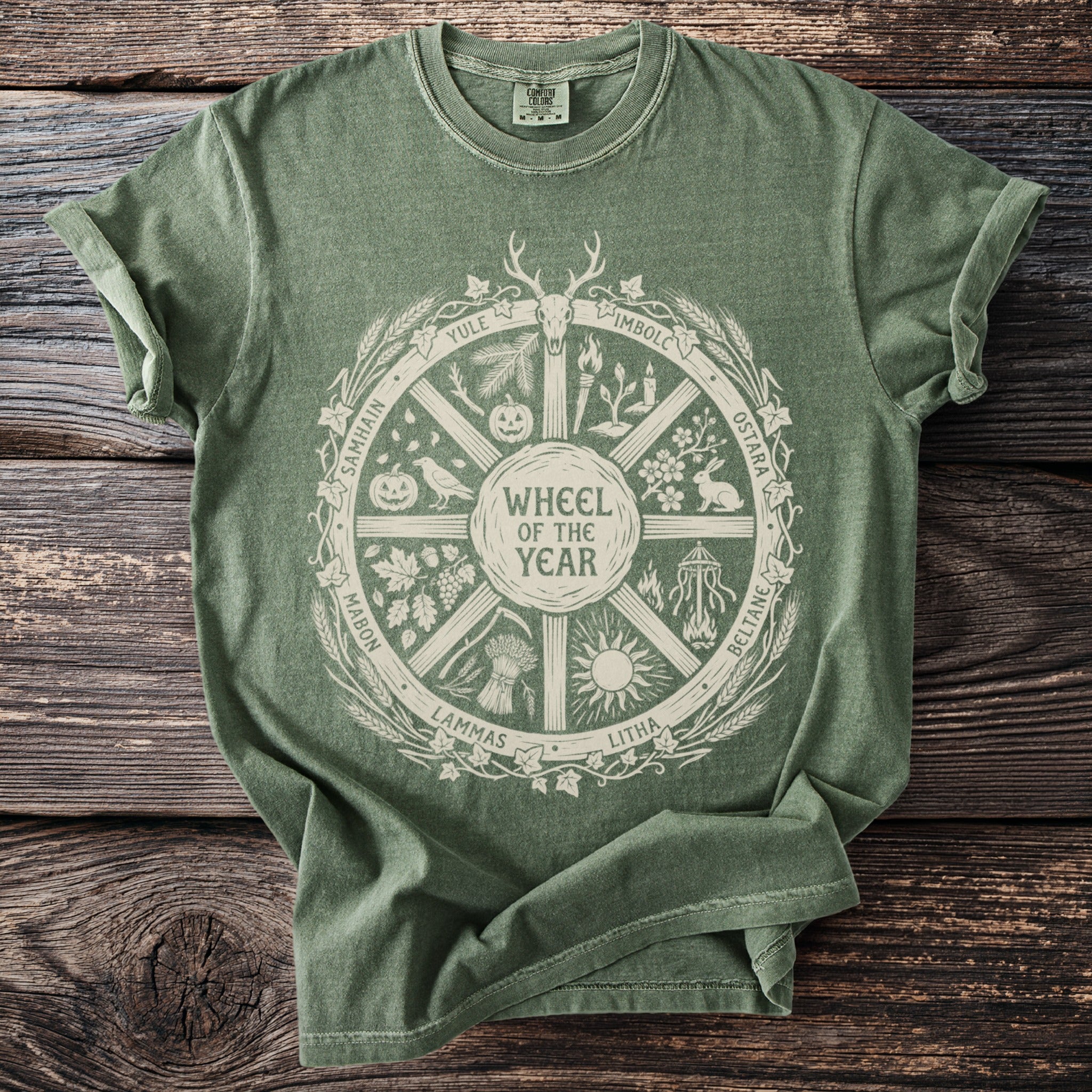 Green t-shirt featuring a "Wheel of the Year" design with seasonal symbols and names.