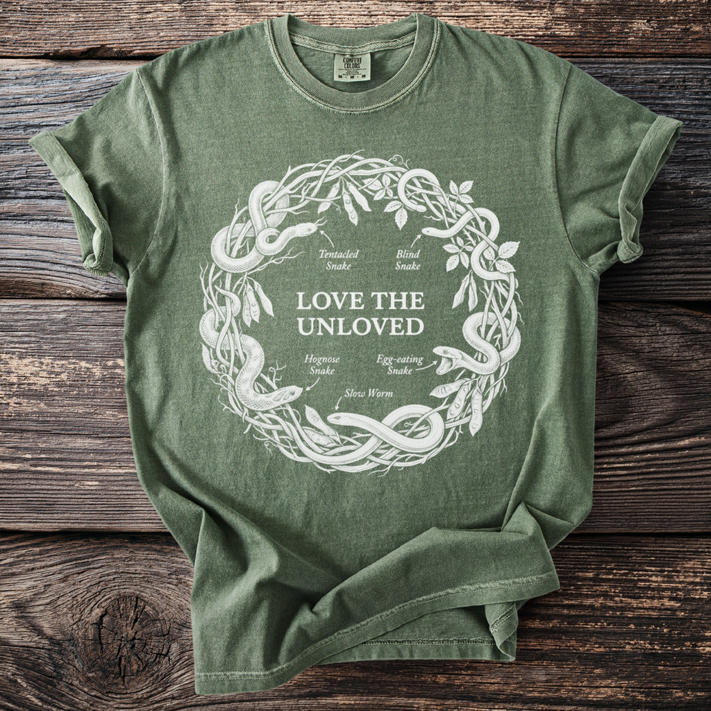 Green t-shirt with white circular snake diagram and text "LOVE THE UNLOVED".