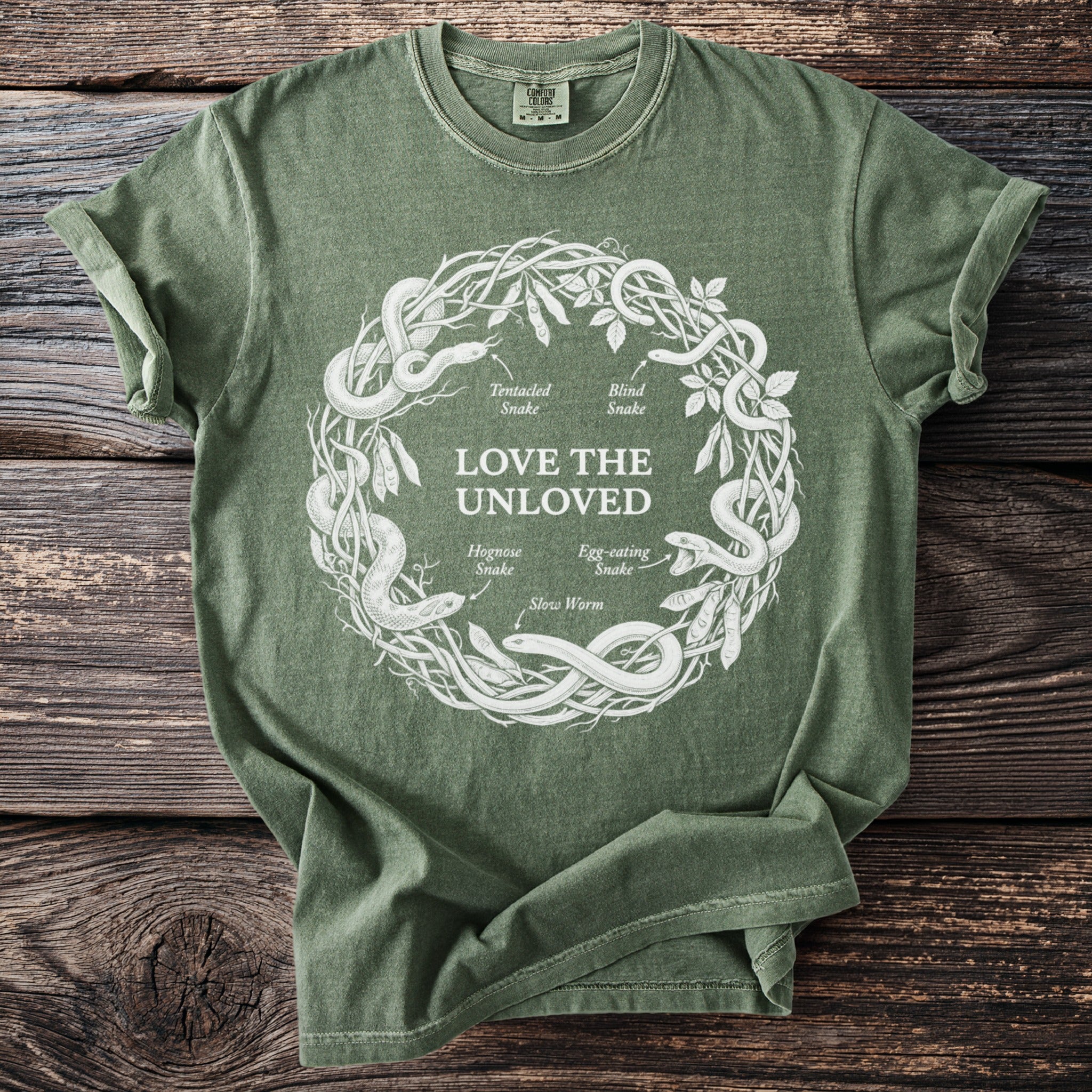 Green t-shirt with white circular snake diagram and text "LOVE THE UNLOVED".