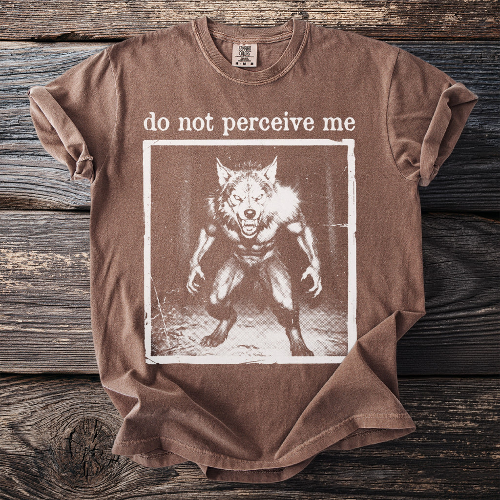 Brown t-shirt with "do not perceive me" and werewolf graphic.